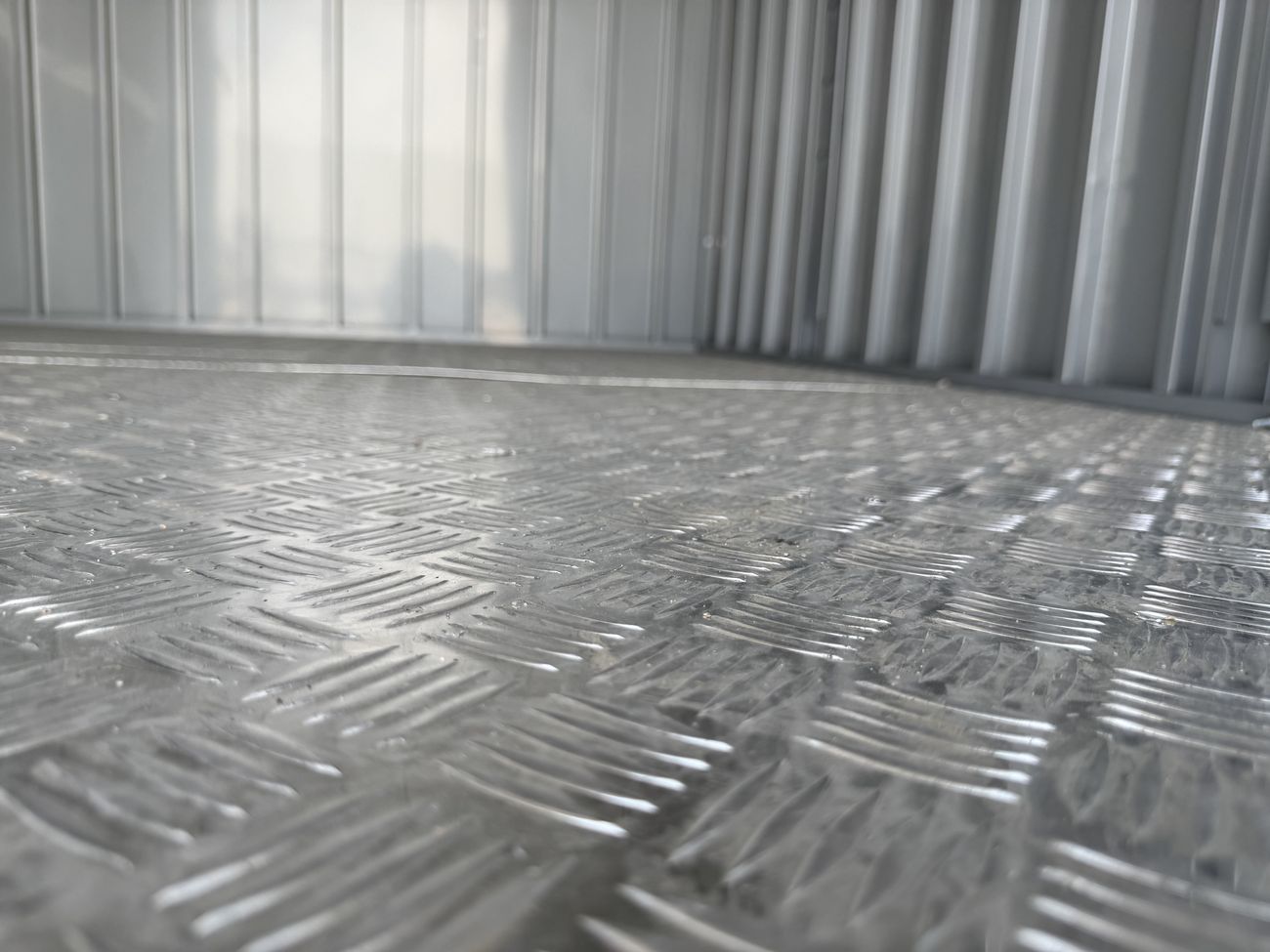 Diamond-plate steel floor shrugs off coolers, kegs, and foot traffic.