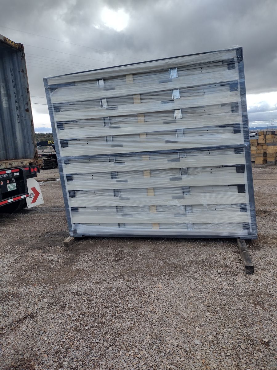 Office unit panels flat-packed and wrapped on a pallet