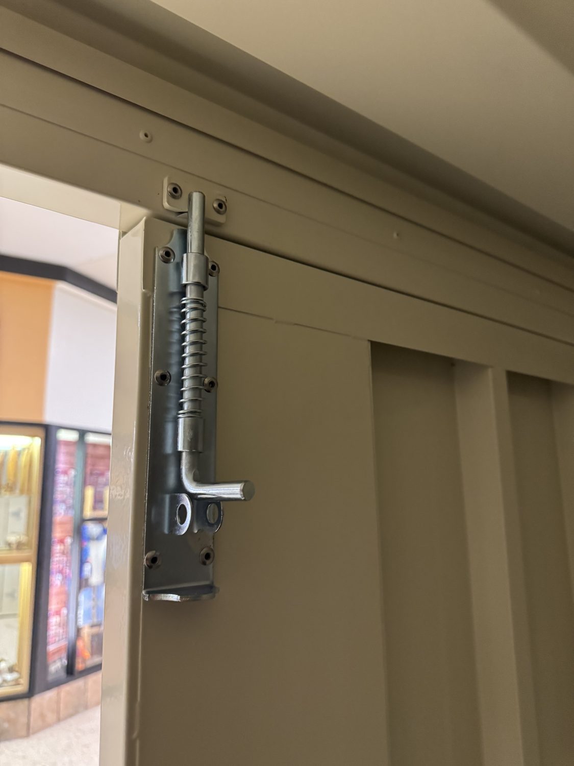 A real spring-loaded slide-bolt, padlock-ready, not a plastic clasp.